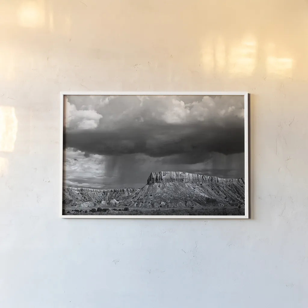 Storms on the Mesa by Debra Van Swearingen. shown as a paper print in a white frame. Available as a archival giclee rolled canvas, fine art paper, or poster print. SKU 19412i.