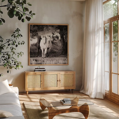 Three Wild Horses Sepia Crop by Debra Van Swearingen. Shown in a natural wood frame in a cozy modern living room. Available as an archival giclee rolled canvas, fine art paper, or poster print. SKU 52847a.