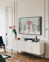 Holiday Ride I Red and Green by Dina June. shown as a framed stretched canvas in a living room above a console. Available as a archival giclee rolled canvas, fine art paper, or poster print. SKU 75112i.