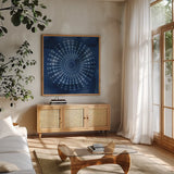 Indigo Splash V by Dina June. Shown in a natural wood frame in a cozy modern living room. Available as an archival giclee rolled canvas, fine art paper, or poster print. SKU 71924a.