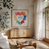 Rainbow Love Pride by Dina June. Shown in a natural wood frame in a cozy modern living room. Available as an archival giclee rolled canvas, fine art paper, or poster print. SKU 85453a.