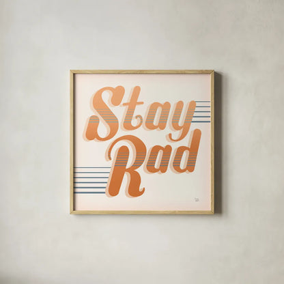 Stay Rad I Warm by Dina June. Shown in a natural wood glass frame for a timeless modern aesthetic. Available as an archival giclee rolled canvas, fine art paper, or poster print. SKU 66918a.