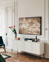 Daisies I Neutral by Elizabeth Urquhart. shown as a framed stretched canvas in a living room above a console. Available as a archival giclee rolled canvas, fine art paper, or poster print. SKU 71601i.