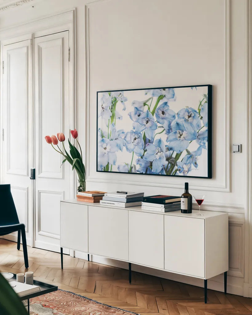 Freshly Picked Delphinium I by Elizabeth Urquhart. shown as a framed stretched canvas in a living room above a console. Available as a archival giclee rolled canvas, fine art paper, or poster print. SKU 67966i.