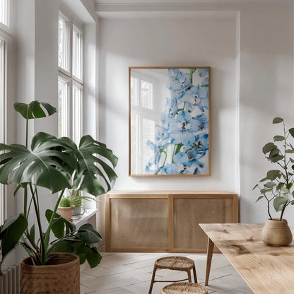 Freshly Picked Delphinium III by Elizabeth Urquhart. shown as a print in a natural wood frame in a dining room. Available as a archival giclee rolled canvas, fine art paper, or poster print. SKU 67968h.