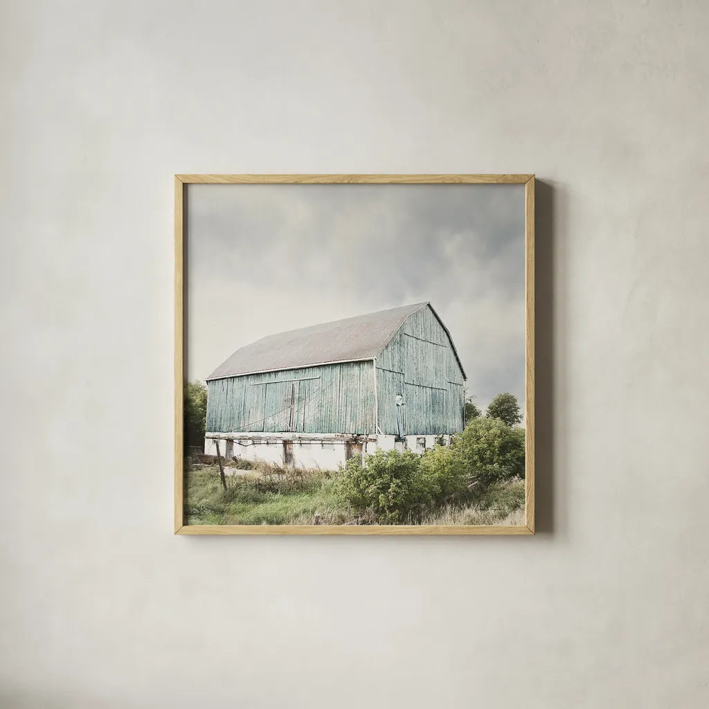 Late Summer Barn I Crop by Elizabeth Urquhart. Shown in a natural wood glass frame for a timeless modern aesthetic. Available as an archival giclee rolled canvas, fine art paper, or poster print. SKU 30333a.