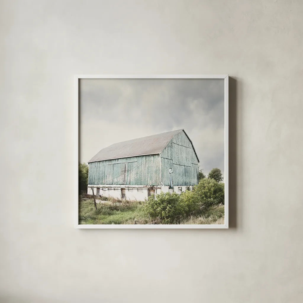 Late Summer Barn I Crop by Elizabeth Urquhart. Shown in a crisp white glass frame for a clean and minimalist style. Available as an archival giclee rolled canvas, fine art paper, or poster print. SKU 30333a.