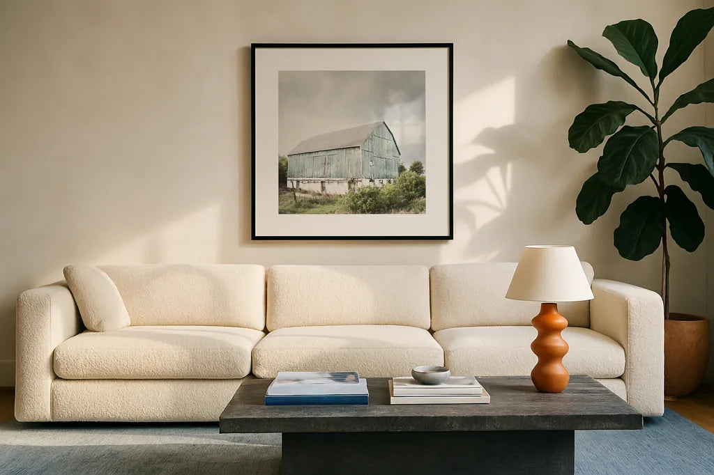 Late Summer Barn I Crop by Elizabeth Urquhart. Displayed in a glass frame with matte in a clean modern living room. Available as an archival giclee rolled canvas, fine art paper, or poster print. SKU 30333a.
