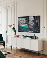 Rowboat II by Elizabeth Urquhart. shown as a framed stretched canvas in a living room above a console. Available as a archival giclee rolled canvas, fine art paper, or poster print. SKU 22326i.