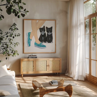 Cutie Kitties III by Emily Adams. Shown in a natural wood frame in a cozy modern living room. Available as an archival giclee rolled canvas, fine art paper, or poster print. SKU 44465a.