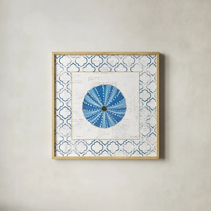 Navy Circular Shell on Newsprint with Gold by Emily Adams. Shown in a natural wood glass frame for a timeless modern aesthetic. Available as an archival giclee rolled canvas, fine art paper, or poster print. SKU 23562a.