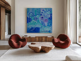 Blue Flora Abstract by Farida Zaman. Shown as extra-large giant wall art in a modern living room. Available as an archival giclee rolled canvas, fine art paper, or poster print. SKU 60944a.