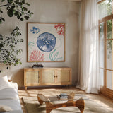 Coastal Jewels IV Coral Cove by Farida Zaman. Shown in a natural wood frame in a cozy modern living room. Available as an archival giclee rolled canvas, fine art paper, or poster print. SKU 55926a.