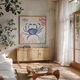 Coastal Jewels V Coral Cove by Farida Zaman. Shown in a natural wood frame in a cozy modern living room. Available as an archival giclee rolled canvas, fine art paper, or poster print. SKU 55927a.
