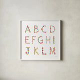Floral Alphabet Sq I by Farida Zaman. Shown in a crisp white glass frame for a clean and minimalist style. Available as an archival giclee rolled canvas, fine art paper, or poster print. SKU 65967a.