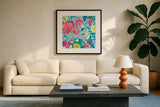 Fruity Flamingos II by Farida Zaman. Displayed in a glass frame with matte in a clean modern living room. Available as an archival giclee rolled canvas, fine art paper, or poster print. SKU 74747a.