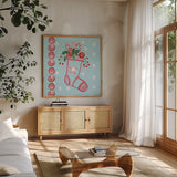 Holiday Treats I by Farida Zaman. Shown in a natural wood frame in a cozy modern living room. Available as an archival giclee rolled canvas, fine art paper, or poster print. SKU 33051a.