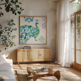 Jewel Peacocks II by Farida Zaman. Shown in a natural wood frame in a cozy modern living room. Available as an archival giclee rolled canvas, fine art paper, or poster print. SKU 41803a.