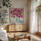 Joyful Tulips by Farida Zaman. Shown in a natural wood frame in a cozy modern living room. Available as an archival giclee rolled canvas, fine art paper, or poster print. SKU 44969a.