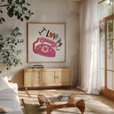 Love You II by Farida Zaman. Shown in a natural wood frame in a cozy modern living room. Available as an archival giclee rolled canvas, fine art paper, or poster print. SKU 104109a.