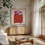 Love You III by Farida Zaman. Shown in a natural wood frame in a cozy modern living room. Available as an archival giclee rolled canvas, fine art paper, or poster print. SKU 104110a.