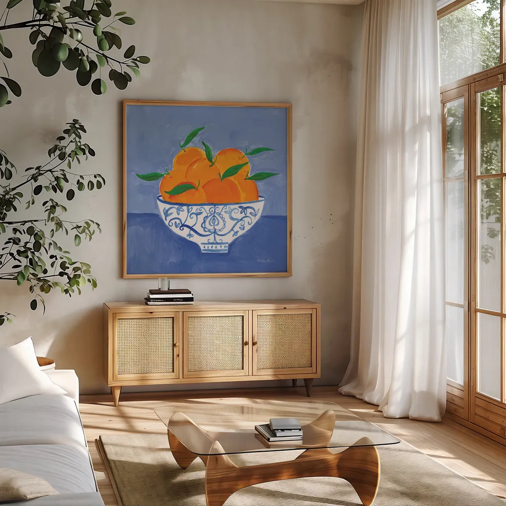 Orange Still Life by Farida Zaman. Shown in a natural wood frame in a cozy modern living room. Available as an archival giclee rolled canvas, fine art paper, or poster print. SKU 78769a.
