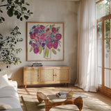 Pink Roses on White by Farida Zaman. Shown in a natural wood frame in a cozy modern living room. Available as an archival giclee rolled canvas, fine art paper, or poster print. SKU 32694a.