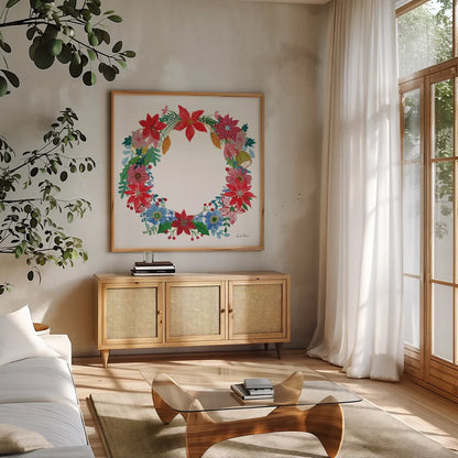 Poinsettia Wreath I by Farida Zaman. Shown in a natural wood frame in a cozy modern living room. Available as an archival giclee rolled canvas, fine art paper, or poster print. SKU 66603a.