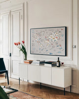 World Map Pastel by Farida Zaman. shown as a framed stretched canvas in a living room above a console. Available as a archival giclee rolled canvas, fine art paper, or poster print. SKU 66679i.