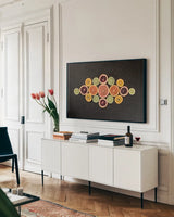 Citrus Drama III by Felicity Bradley. shown as a framed stretched canvas in a living room above a console. Available as a archival giclee rolled canvas, fine art paper, or poster print. SKU 45714i.