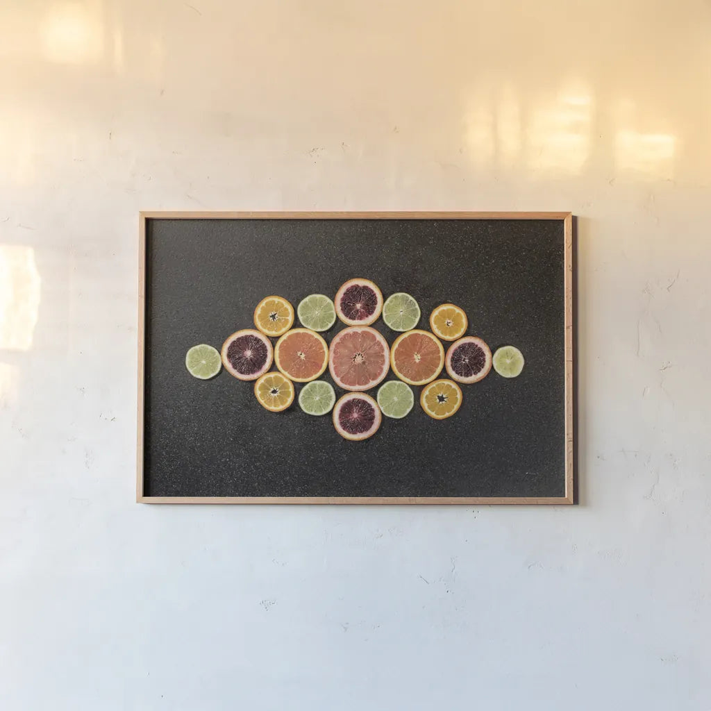 Citrus Drama III by Felicity Bradley. shown as a paper print in a natural frame. Available as a archival giclee rolled canvas, fine art paper, or poster print. SKU 45714i.