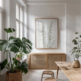 Simple Stems IV Light Crop by Felicity Bradley. shown as a print in a natural wood frame in a dining room. Available as a archival giclee rolled canvas, fine art paper, or poster print. SKU 56819h.