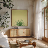 Succulent Simplicity I by Felicity Bradley. Shown in a natural wood frame in a cozy modern living room. Available as an archival giclee rolled canvas, fine art paper, or poster print. SKU 33834a.