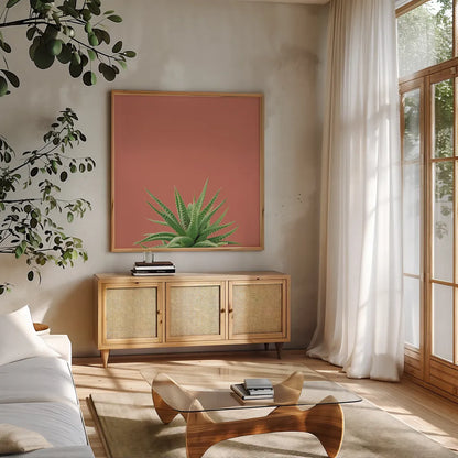 Succulent Simplicity I Coral by Felicity Bradley. Shown in a natural wood frame in a cozy modern living room. Available as an archival giclee rolled canvas, fine art paper, or poster print. SKU 54222a.