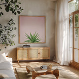Succulent Simplicity I on Pink by Felicity Bradley. Shown in a natural wood frame in a cozy modern living room. Available as an archival giclee rolled canvas, fine art paper, or poster print. SKU 34348a.