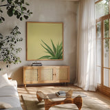 Succulent Simplicity II by Felicity Bradley. Shown in a natural wood frame in a cozy modern living room. Available as an archival giclee rolled canvas, fine art paper, or poster print. SKU 33835a.