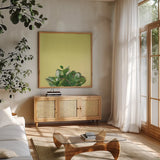 Succulent Simplicity III by Felicity Bradley. Shown in a natural wood frame in a cozy modern living room. Available as an archival giclee rolled canvas, fine art paper, or poster print. SKU 33836a.