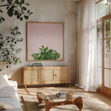Succulent Simplicity III on Pink by Felicity Bradley. Shown in a natural wood frame in a cozy modern living room. Available as an archival giclee rolled canvas, fine art paper, or poster print. SKU 34349a.