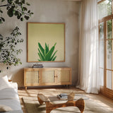 Succulent Simplicity V by Felicity Bradley. Shown in a natural wood frame in a cozy modern living room. Available as an archival giclee rolled canvas, fine art paper, or poster print. SKU 33838a.