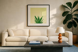Succulent Simplicity V by Felicity Bradley. Displayed in a glass frame with matte in a clean modern living room. Available as an archival giclee rolled canvas, fine art paper, or poster print. SKU 33838a.