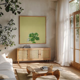 Succulent Simplicity VII by Felicity Bradley. Shown in a natural wood frame in a cozy modern living room. Available as an archival giclee rolled canvas, fine art paper, or poster print. SKU 33840a.