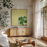 Succulent Simplicity VIII by Felicity Bradley. Shown in a natural wood frame in a cozy modern living room. Available as an archival giclee rolled canvas, fine art paper, or poster print. SKU 33841a.