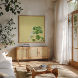 Succulent Simplicity X by Felicity Bradley. Shown in a natural wood frame in a cozy modern living room. Available as an archival giclee rolled canvas, fine art paper, or poster print. SKU 33843a.