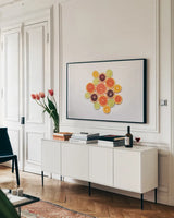 Sunny Citrus I by Felicity Bradley. shown as a framed stretched canvas in a living room above a console. Available as a archival giclee rolled canvas, fine art paper, or poster print. SKU 45708i.