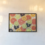 Sunny Citrus IV by Felicity Bradley. shown as a paper print in a black flame. Available as a archival giclee rolled canvas, fine art paper, or poster print. SKU 45711i.