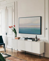 Blue View by James Wiens. shown as a framed stretched canvas in a living room above a console. Available as a archival giclee rolled canvas, fine art paper, or poster print. SKU 75170i.