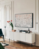Bringing in Blossoms Blush by James Wiens. shown as a framed stretched canvas in a living room above a console. Available as a archival giclee rolled canvas, fine art paper, or poster print. SKU 45677i.