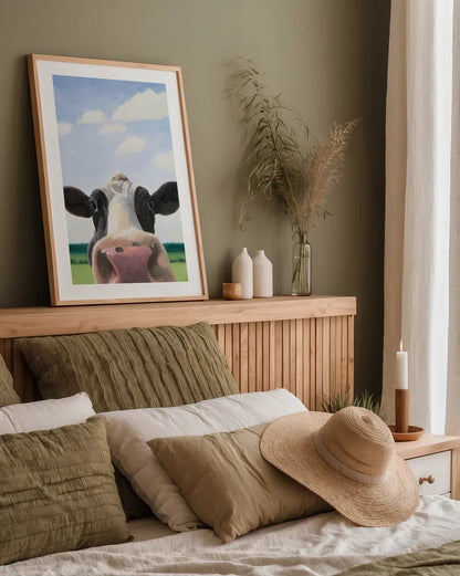 Funny Cow by James Wiens. shown as a paper print in a natural frame. Available as a archival giclee rolled canvas, fine art paper, or poster print. SKU 76092h.