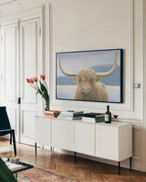 Highland Cow by James Wiens. shown as a framed stretched canvas in a living room above a console. Available as a archival giclee rolled canvas, fine art paper, or poster print. SKU 50229i.