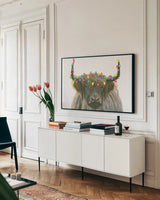 Holiday Highlander by James Wiens. shown as a framed stretched canvas in a living room above a console. Available as a archival giclee rolled canvas, fine art paper, or poster print. SKU 56448i.